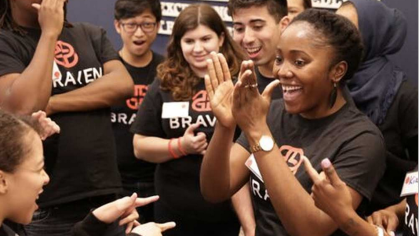 students wearing Braven t-shirts cheering for each other - cropped