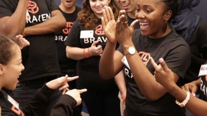 Students wearing Braven t-shirts cheering for each other