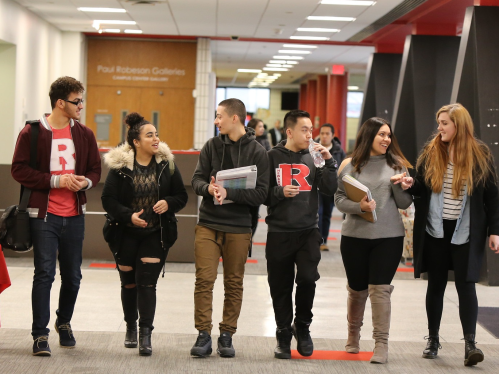 6 students walking in the Paul Robeson Campus Center at Rutgers - Newark